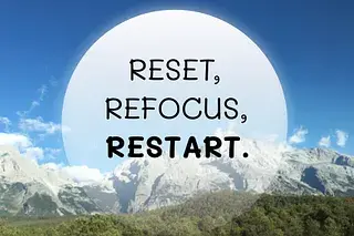Inspirational quote “Reset, Refocus, Restart” over a mountain landscape and clear blue sky.