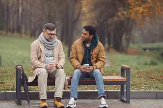 staying-human-connection-two-men-talking-park-bench